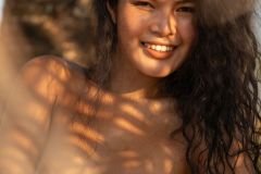 Thai beauty Kathai expresses her wild nature in the shade of a palm tree